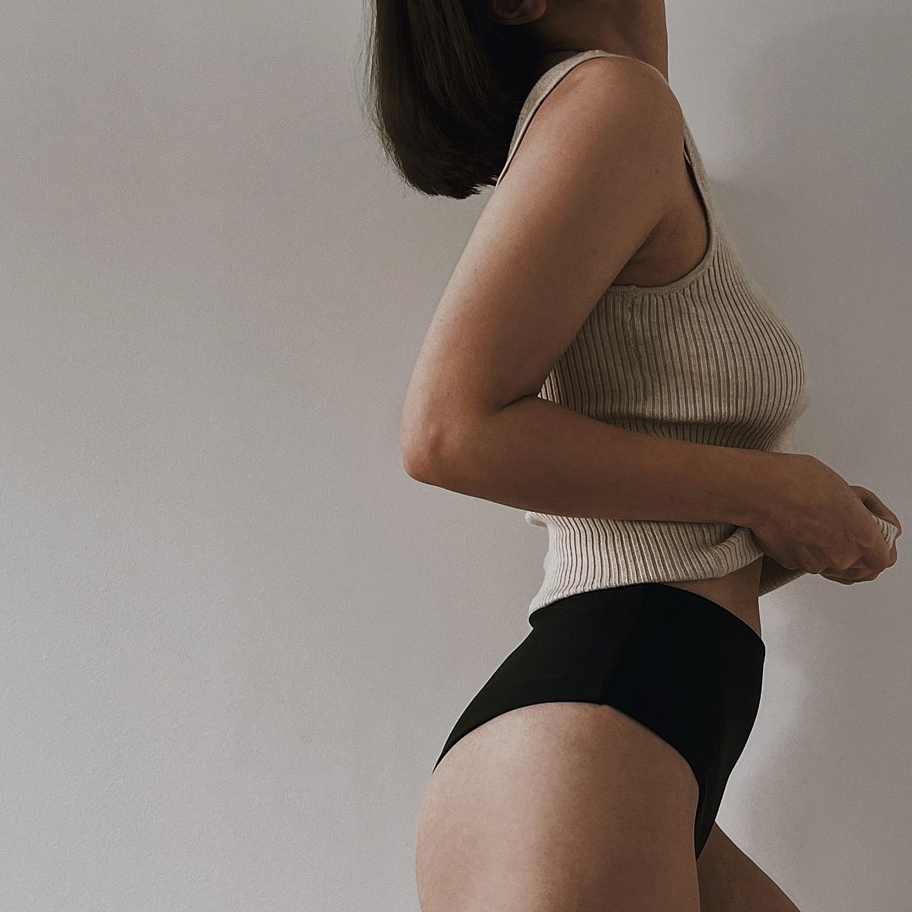 Side view of a woman showing lower body contour changes after major weight loss, related to lower body lift and thigh lift surgery.