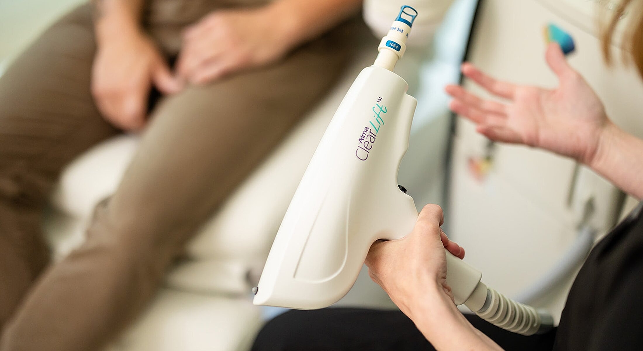 Handheld skincare treatment device in use.