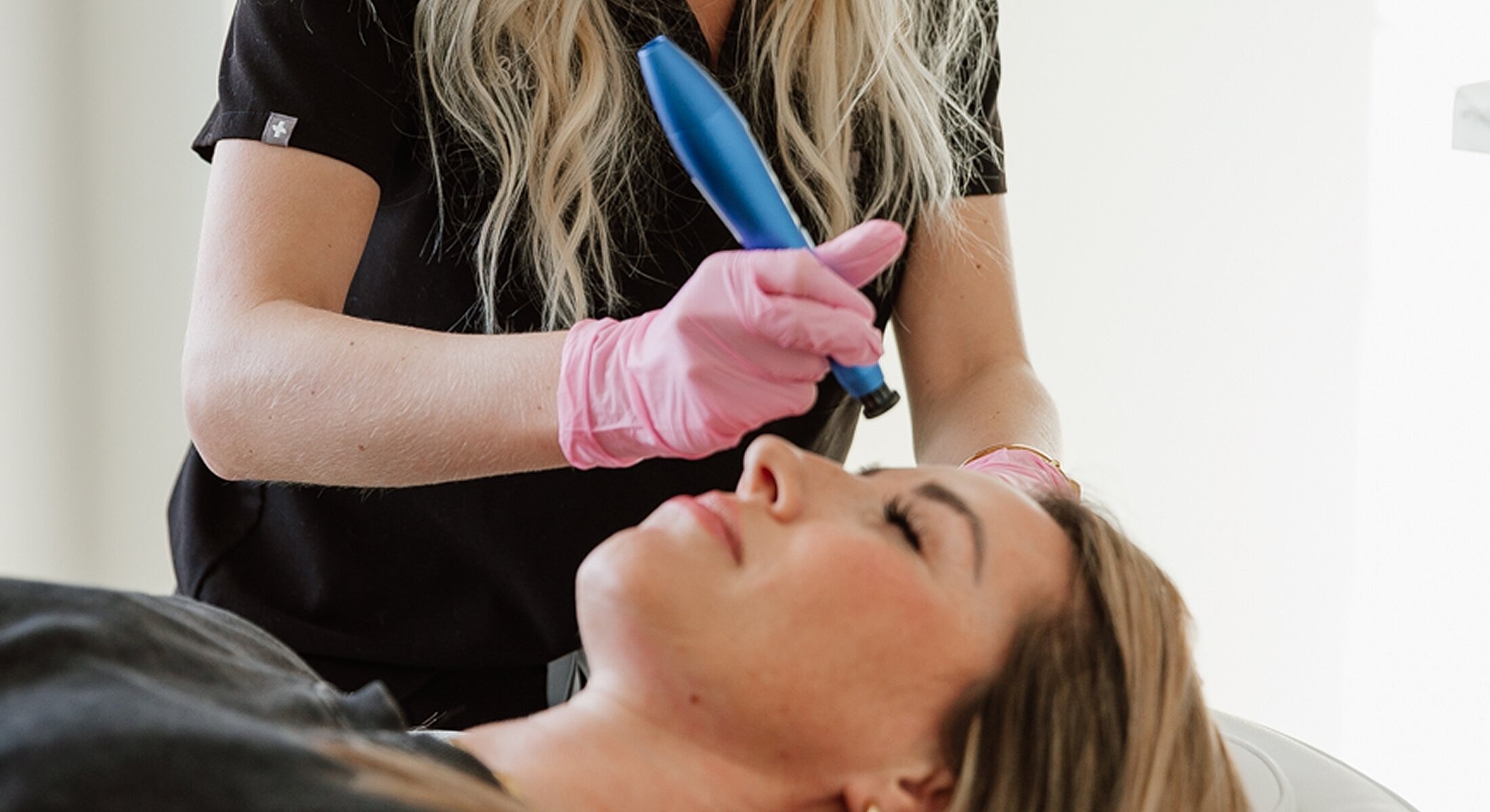 Facial treatment in progress with microneedling device.