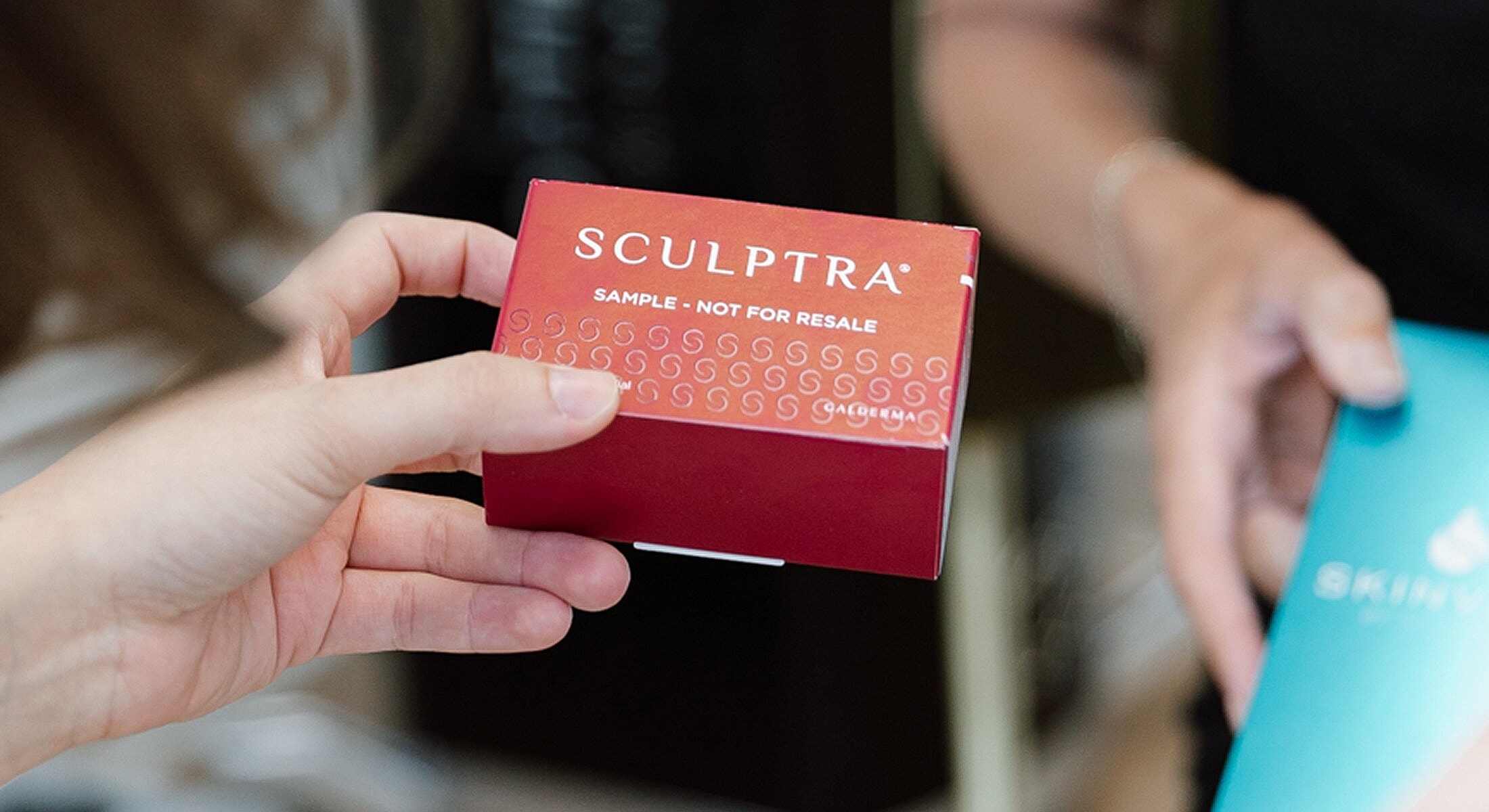 Person holding a Sculptra sample box.