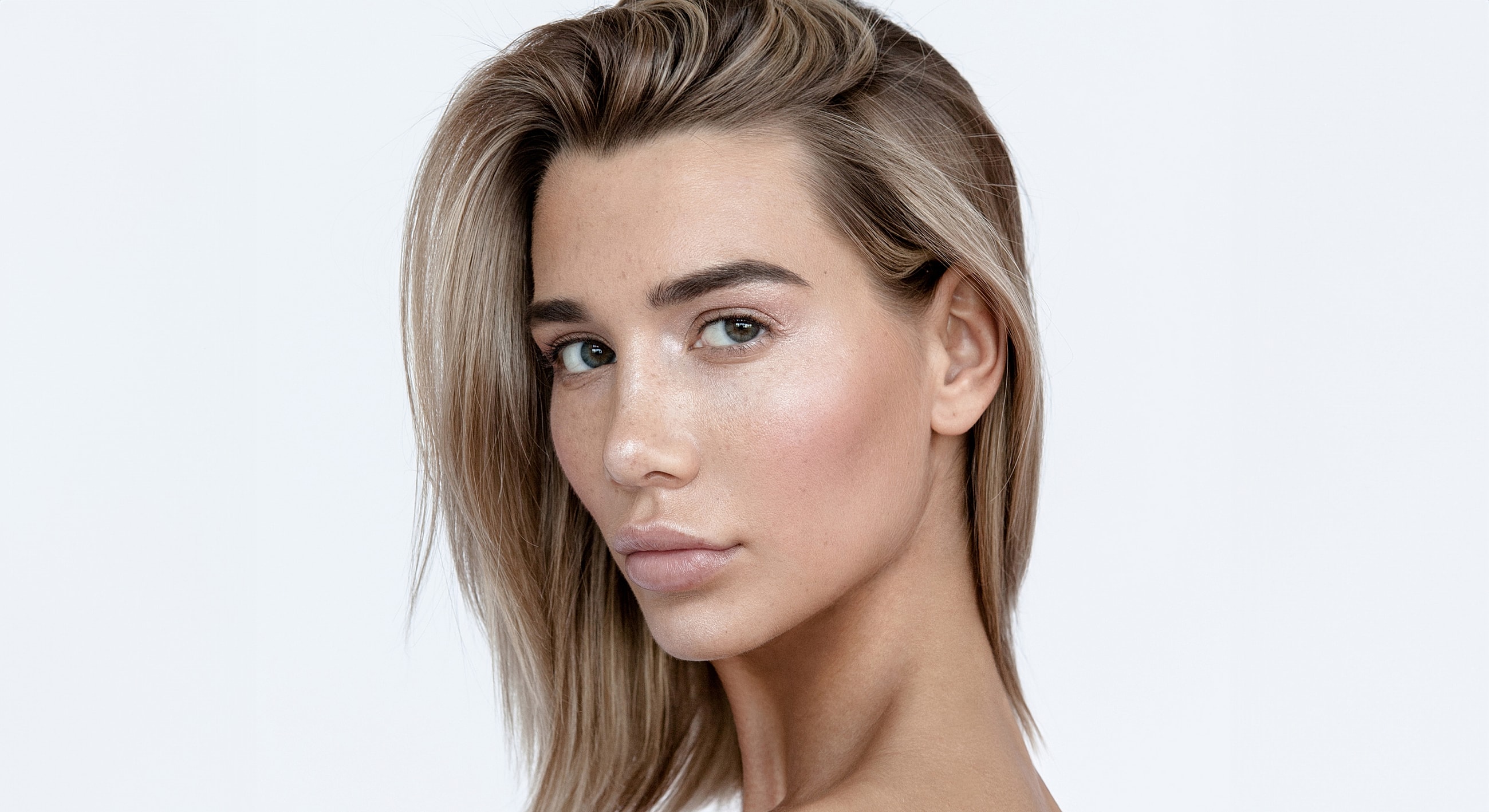 Profile portrait of a woman with blonde hair.