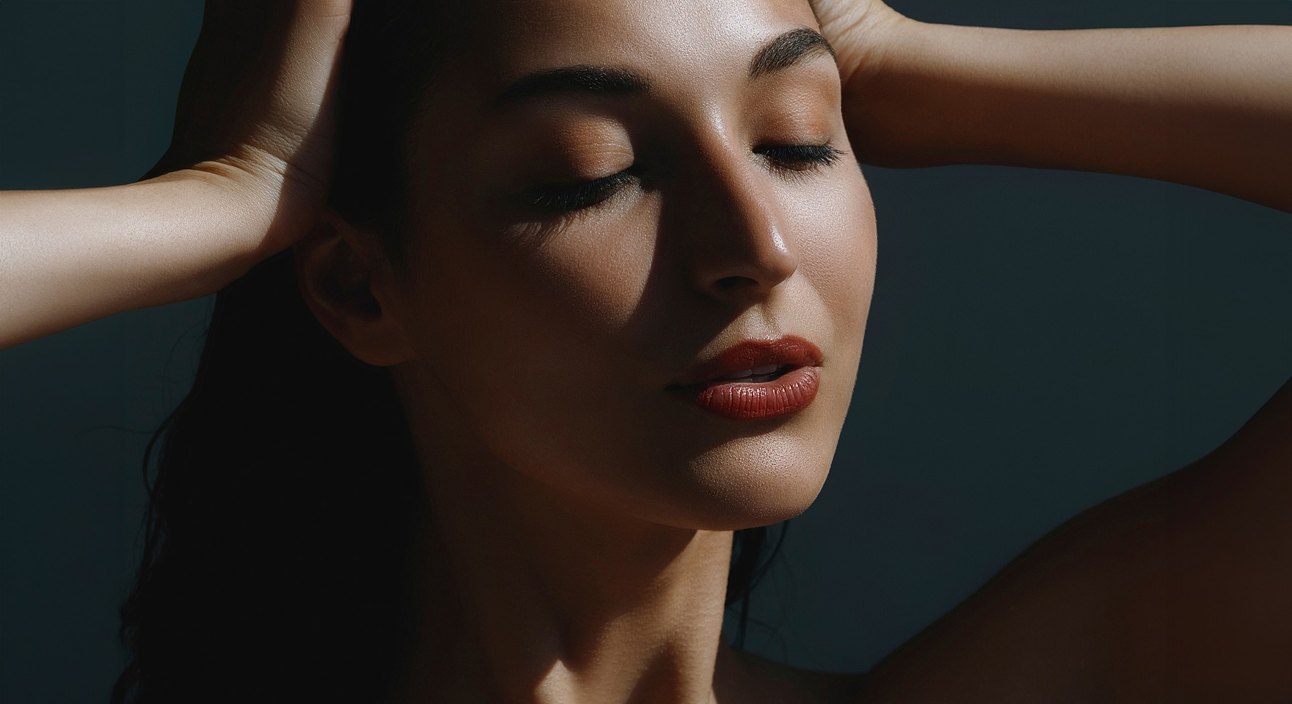 Close-up portrait of a woman with closed eyes.