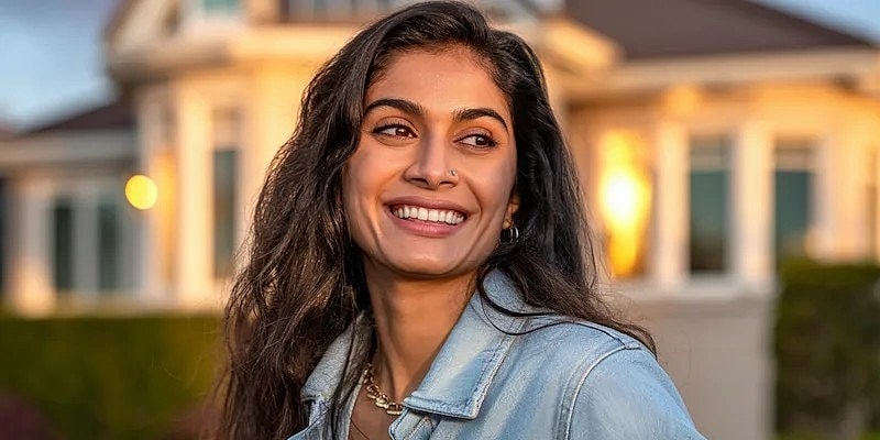 Smiling woman in casual attire outdoors.