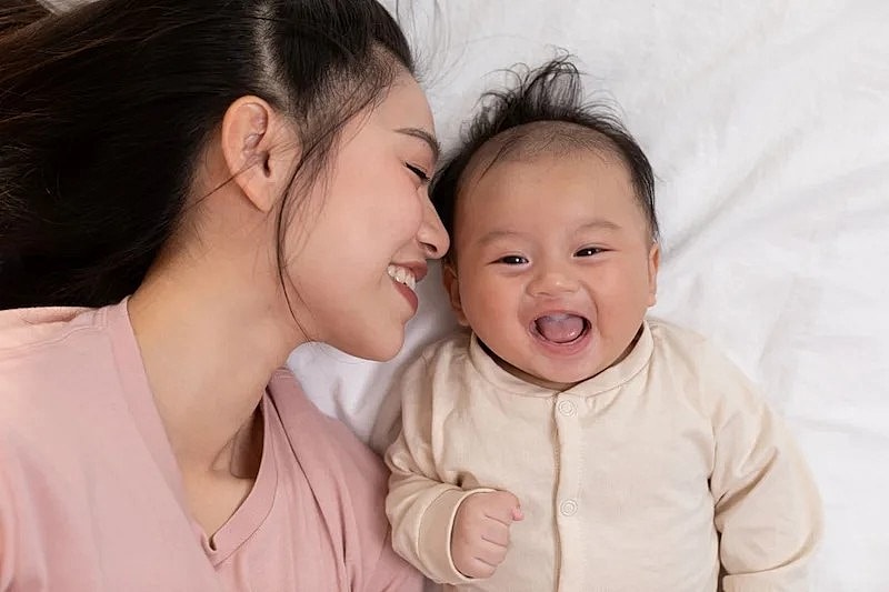 Mother and baby sharing a joyful moment.