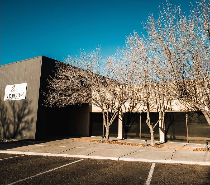 Modern building with bare trees outside.