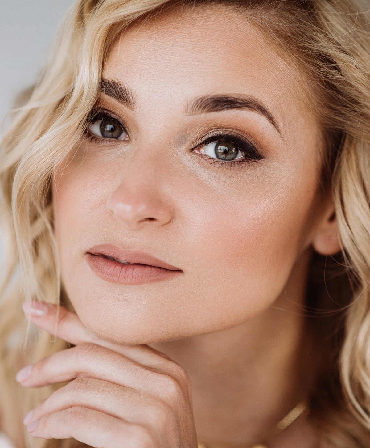 Close-up of a woman with wavy blonde hair.