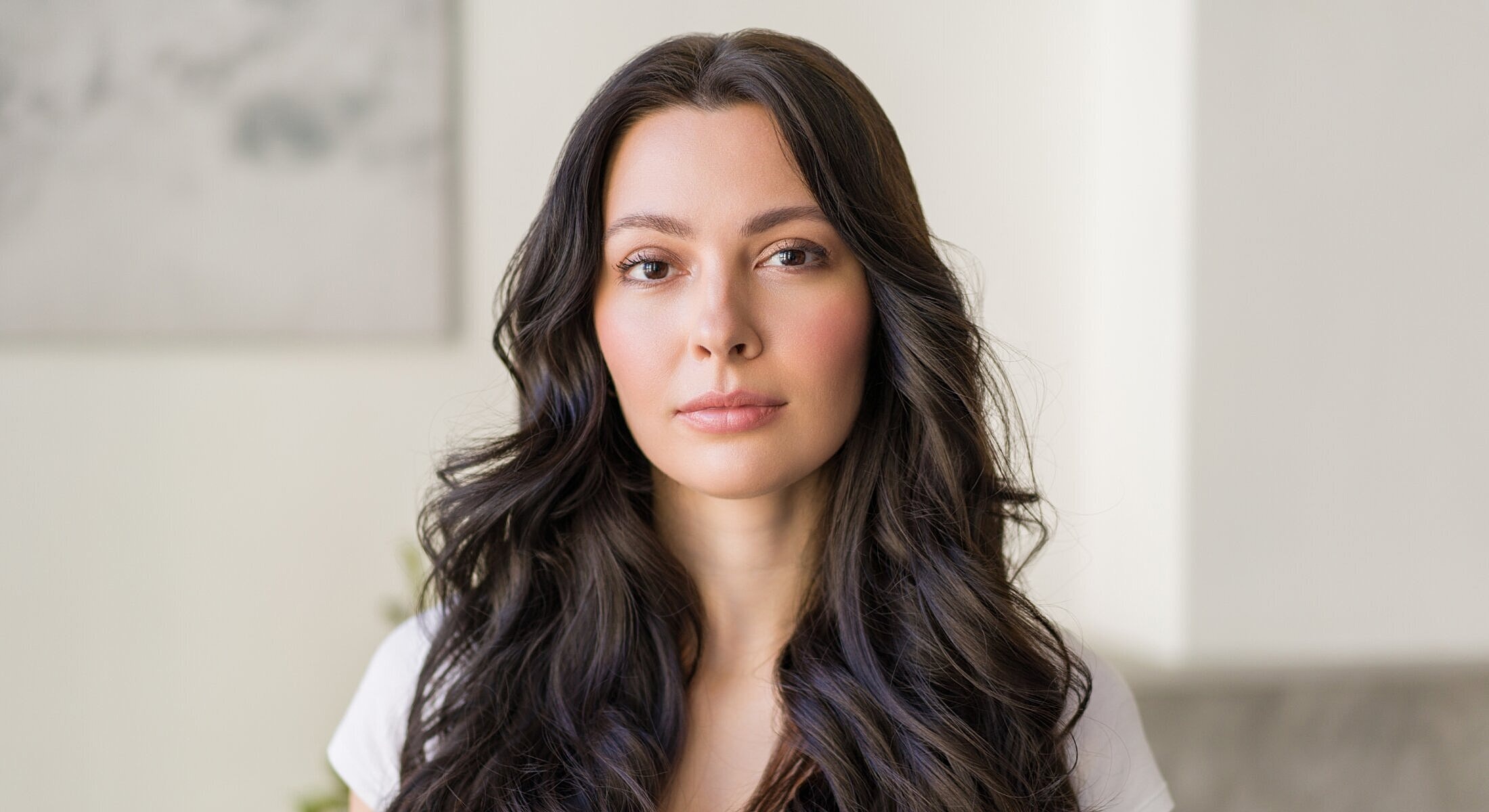 Woman with long, dark hair and natural makeup.