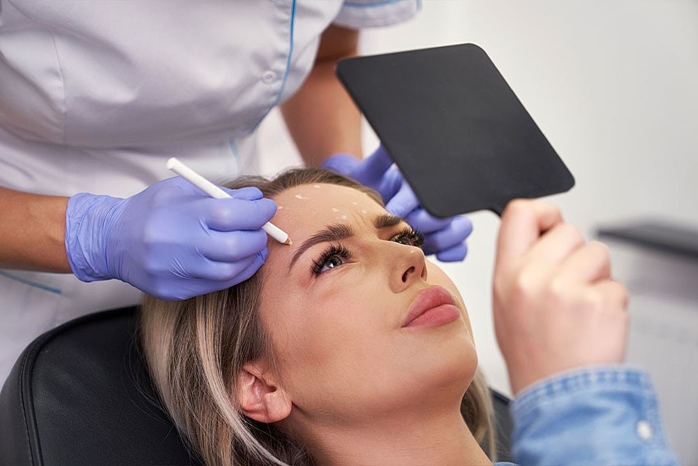 A woman getting marked for Botox in Scottsdale.