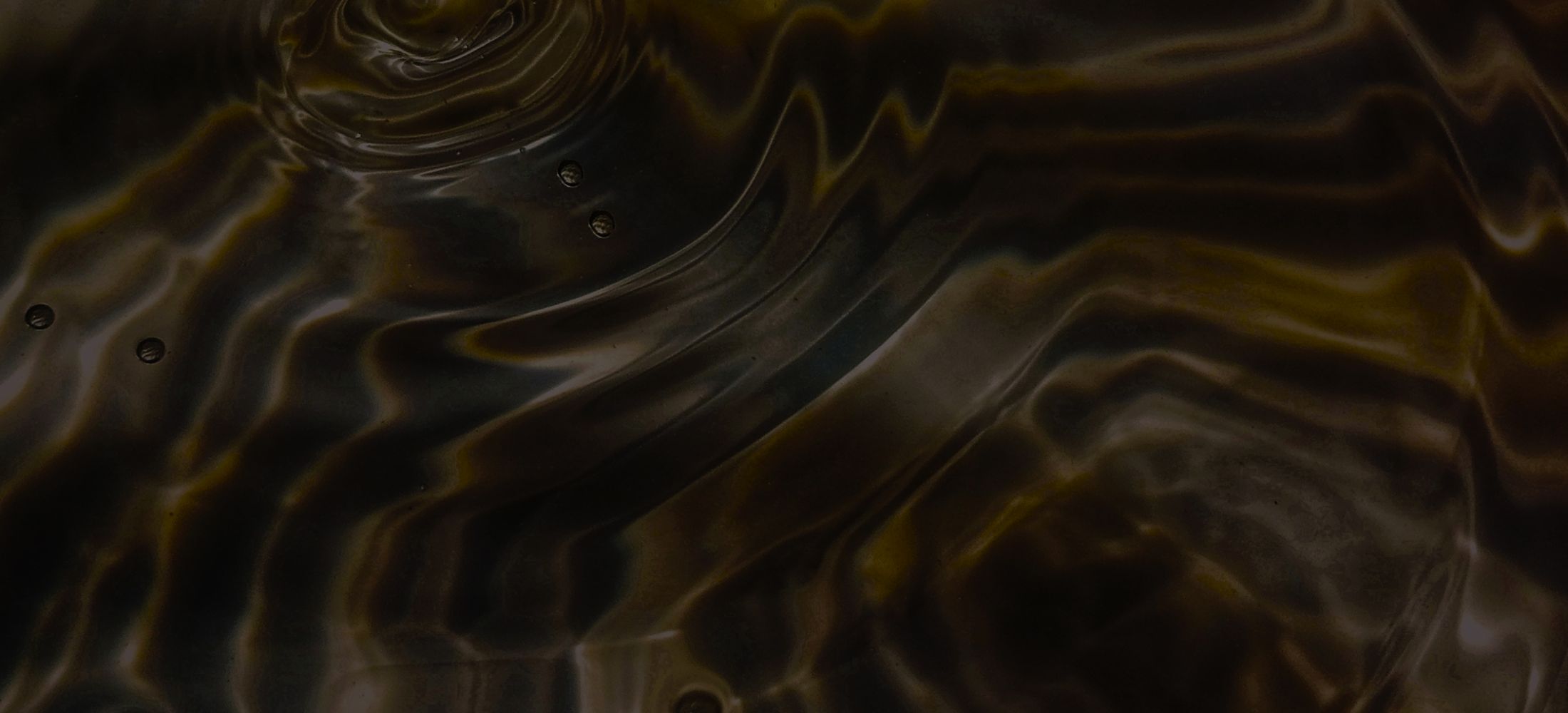 Abstract dark water surface with ripples and textures.