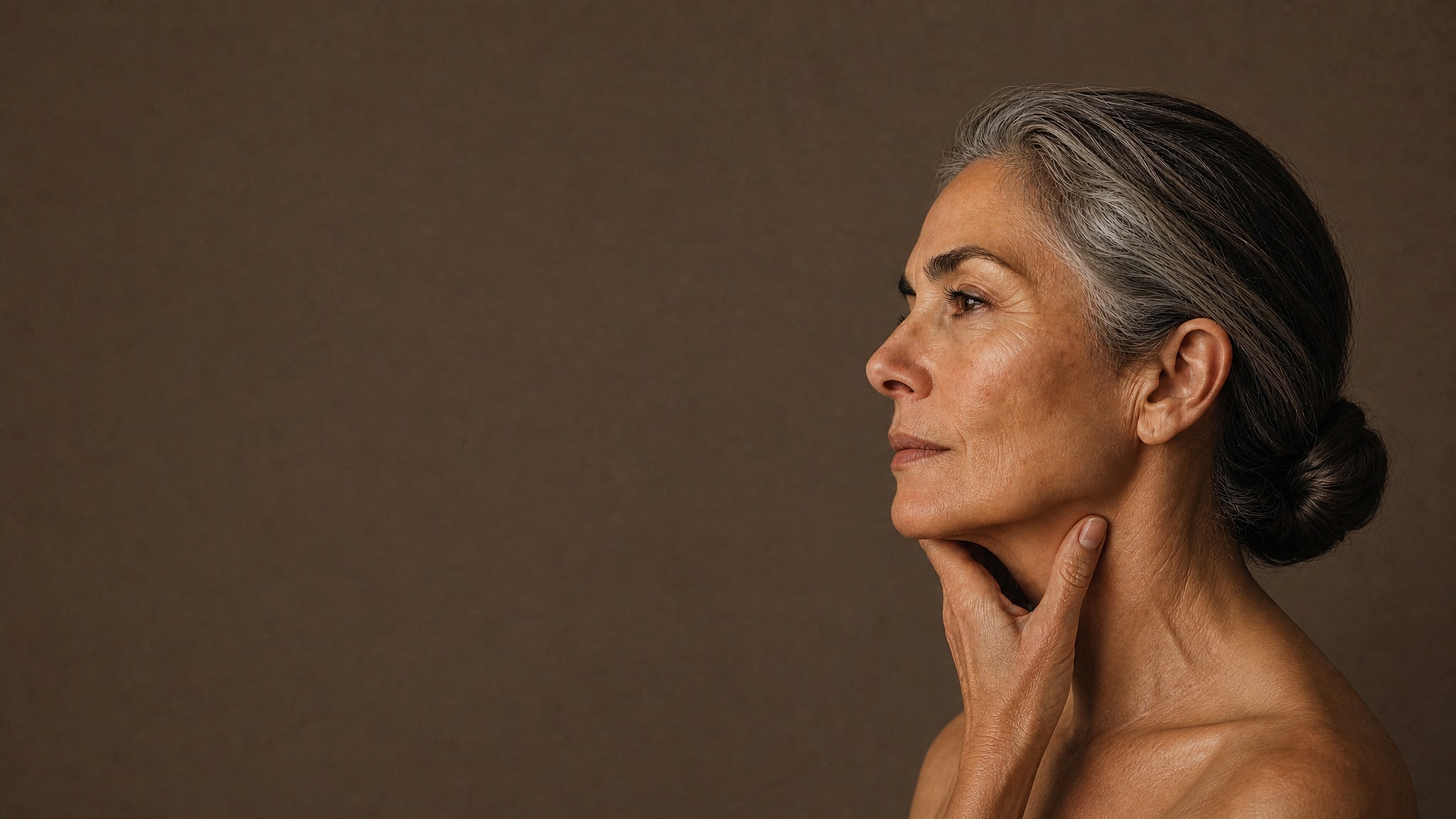 Mature woman in profile, with natural neck lines and skin texture