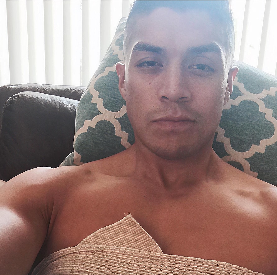 Person resting on a couch, casual indoor setting.