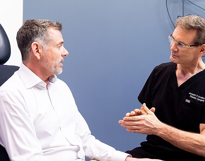 Doctor consulting with patient in office setting.