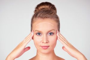 Woman deciding between surgery and fillers for her facial procedure