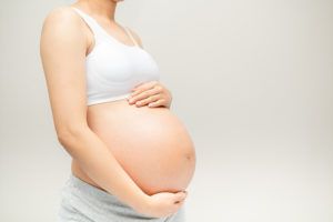 Pregnant woman after a tummy tuck