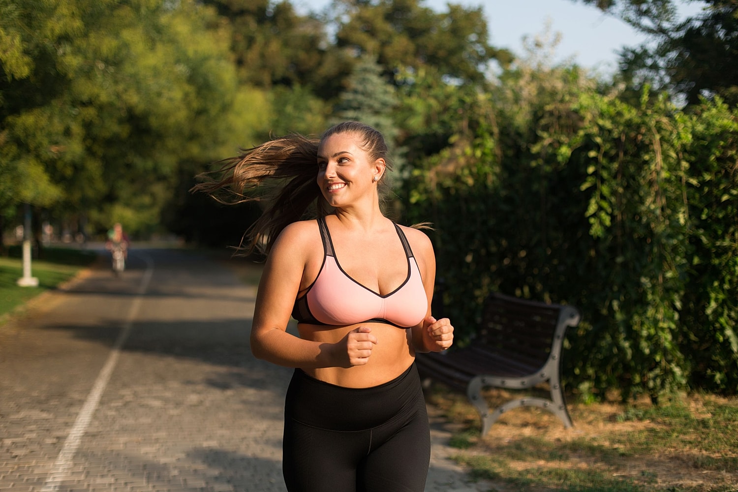 Woman jogging outdoors in athletic wear, illustrating post-weight-loss body contouring and the GLP-1 makeover.