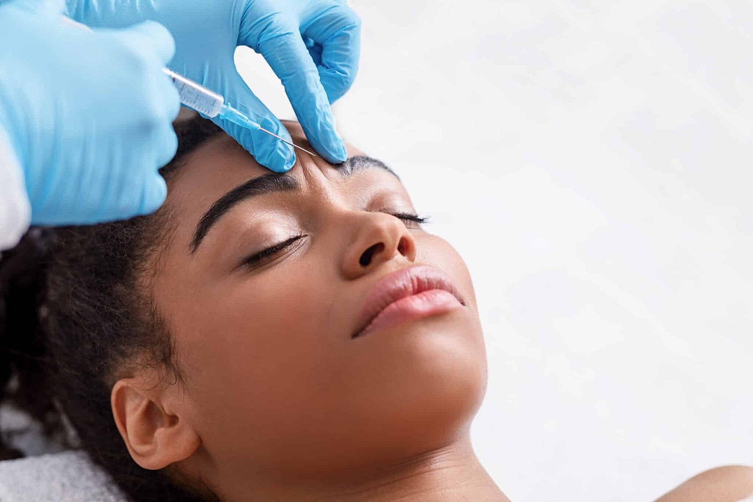 Young woman getting BOTOX treatment at Miami Skin and Vein in Miami, FL, to stop the signs of aging on her face.