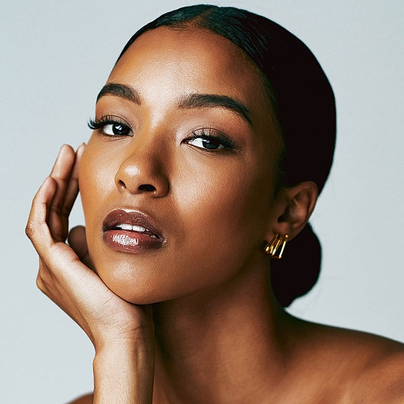 Woman with elegant makeup and soft expression.