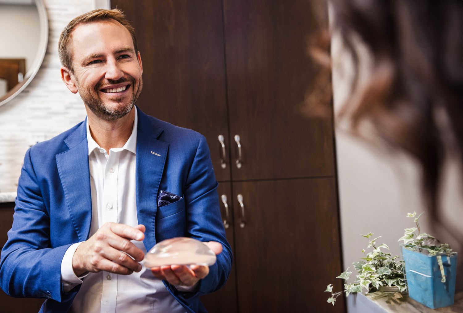 Consultation about cosmetic implants in office setting.