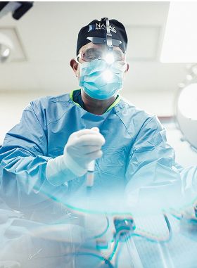 Surgeon performing a procedure in operating room.