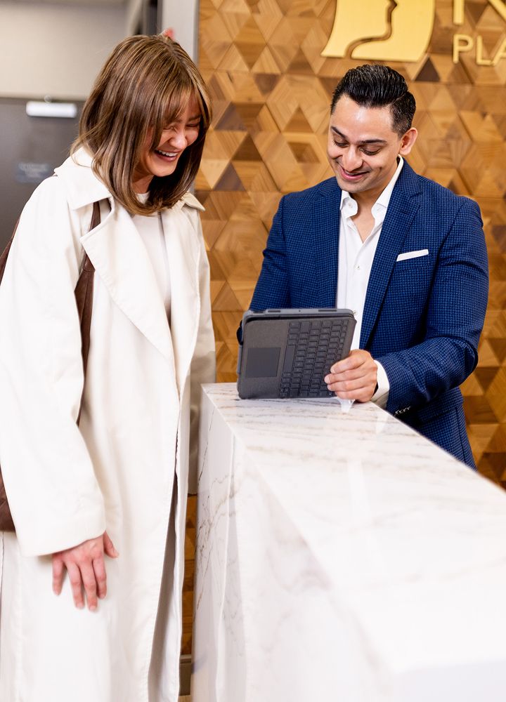 People interacting at a reception desk.