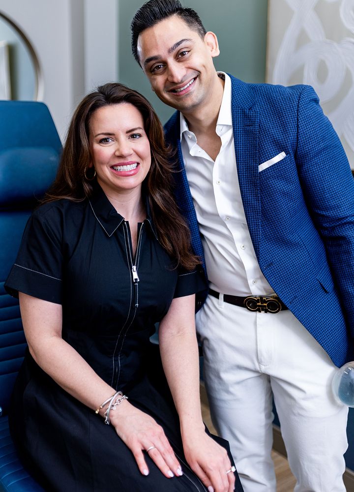 Two professionals smiling in a modern office.