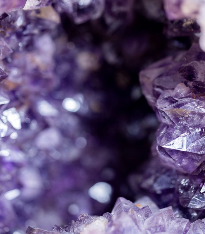 Purple amethyst crystal cluster with sparkling facets.