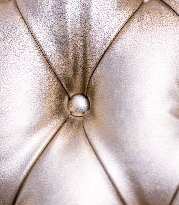 Close-up of tufted metallic upholstery.