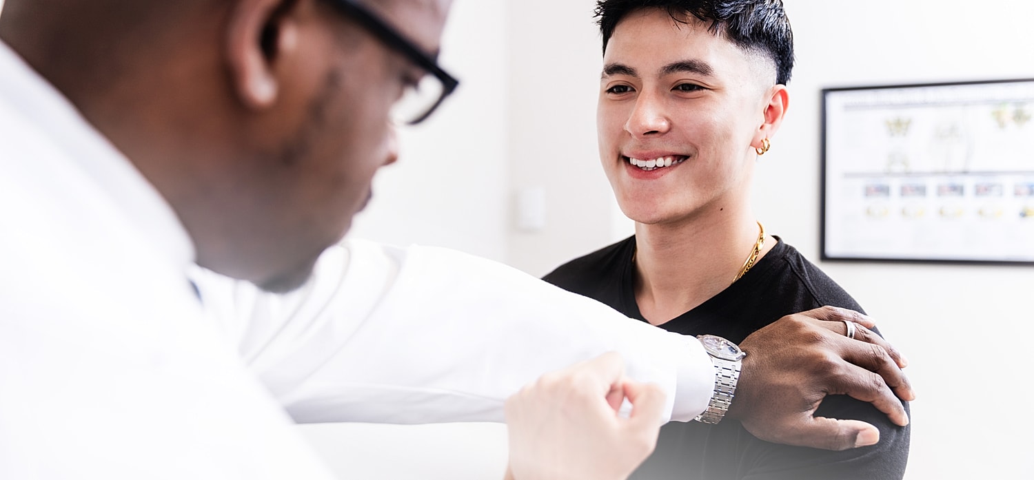Patient smiling during a spine surgeon's consultation.