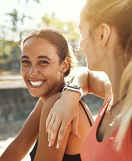 Two friends enjoying a joyful moment outdoors.