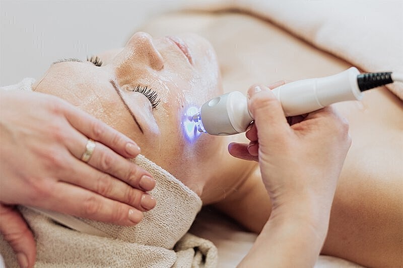 Doctor using lazer on woman's face