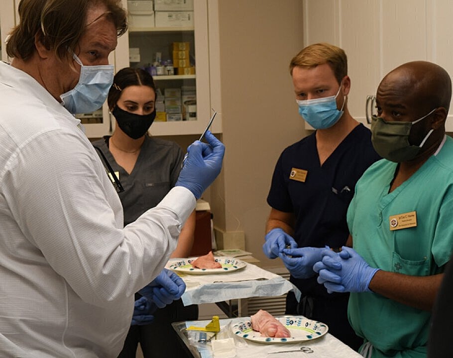 Vero Beach Plastic Surgeon expert Dr. Alan Durkin training others on suture procedure
