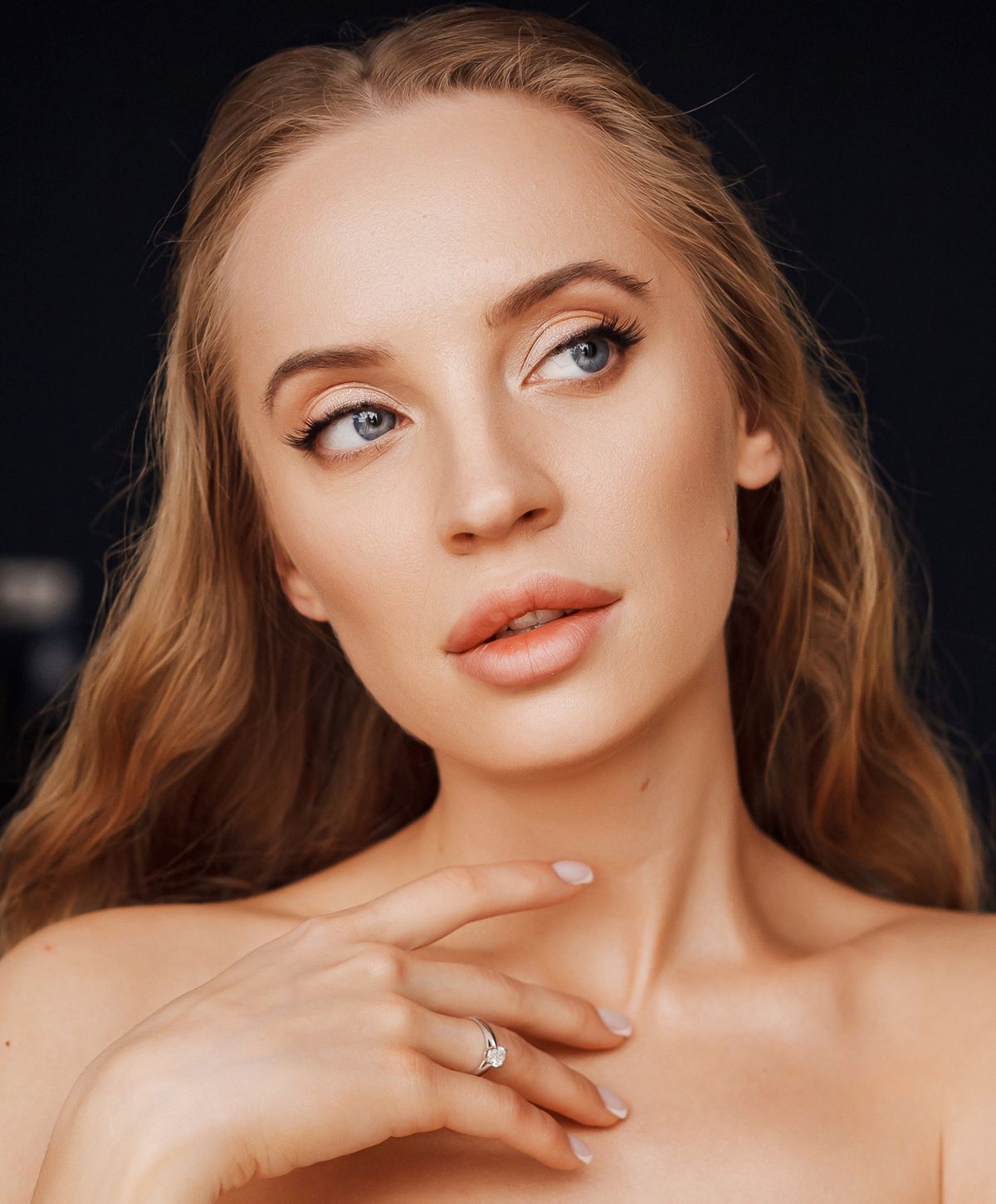 Woman with long hair and elegant makeup.