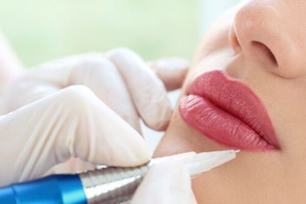 A woman is getting her lips injected with a needle.