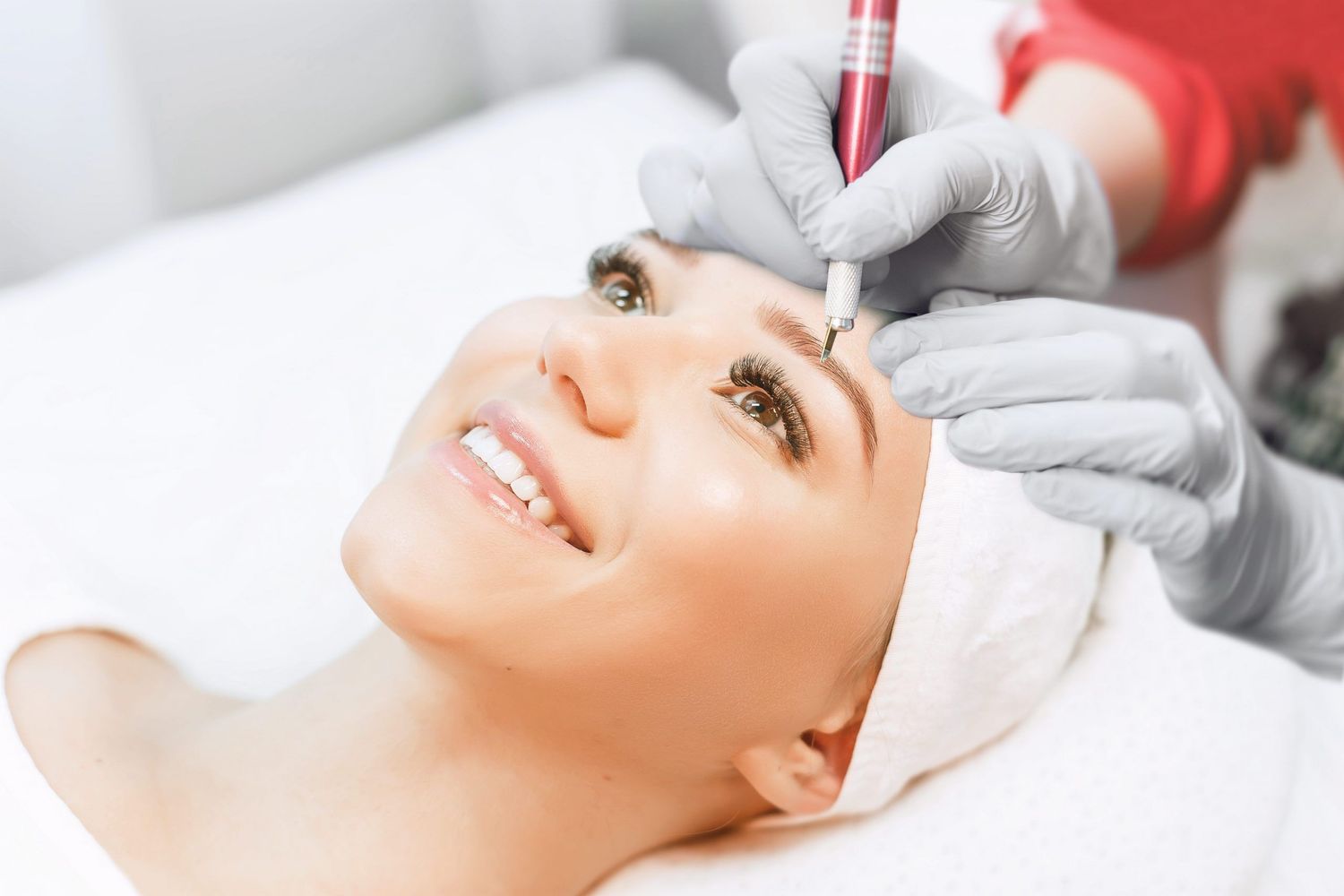 A woman getting her eyebrows done in a beauty salon.