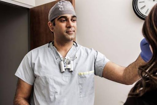 surrey, bc plastic surgeon dr imran ratanshi consulting with a patient