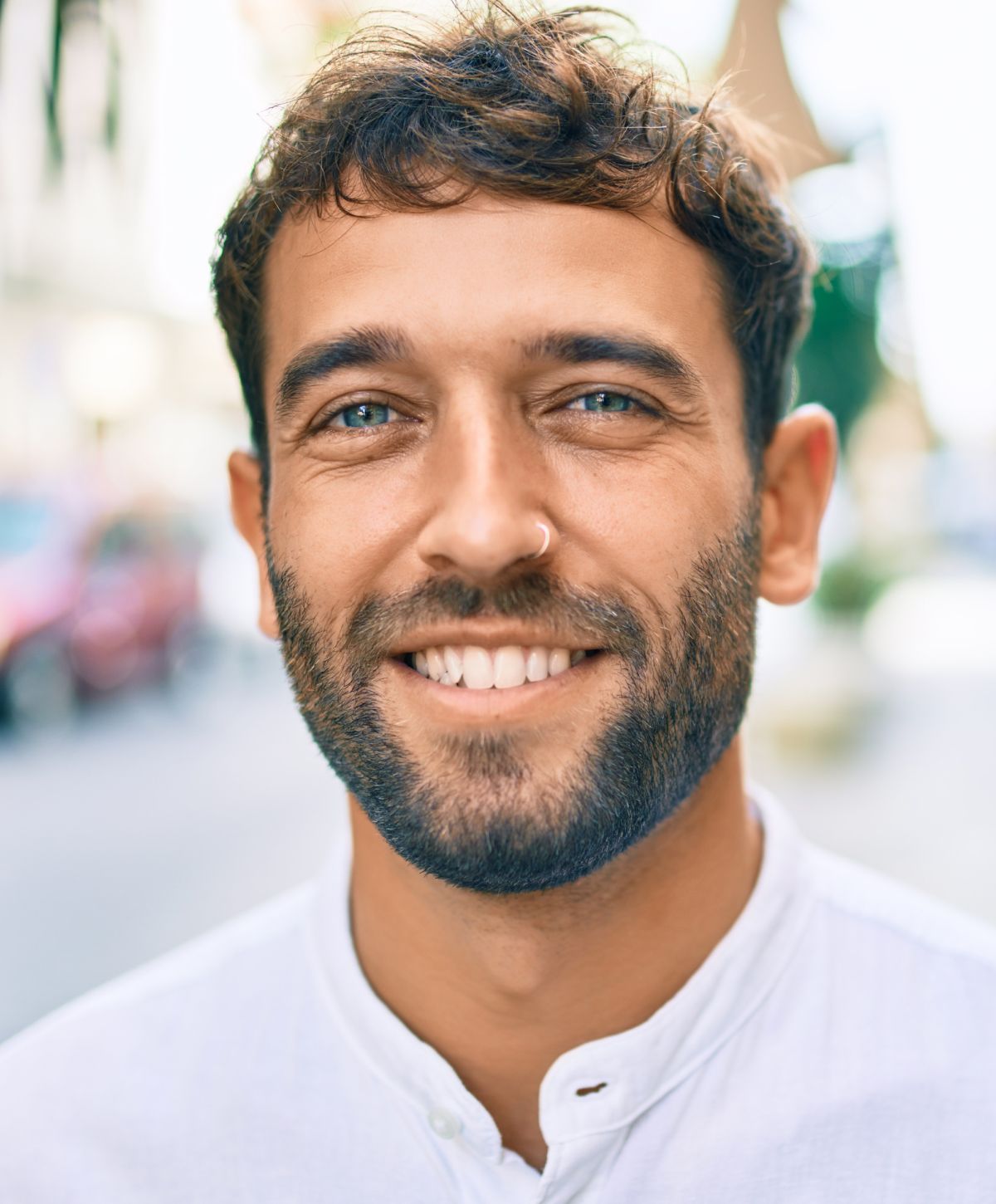 Smiling man with blue eyes in casual attire.