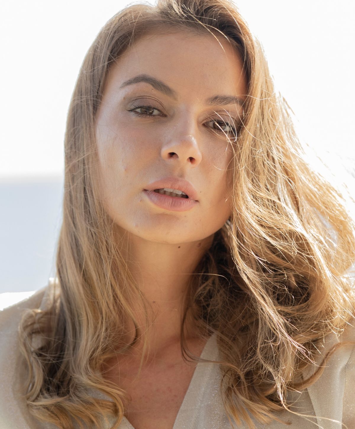 Close-up of a woman with flowing hair.