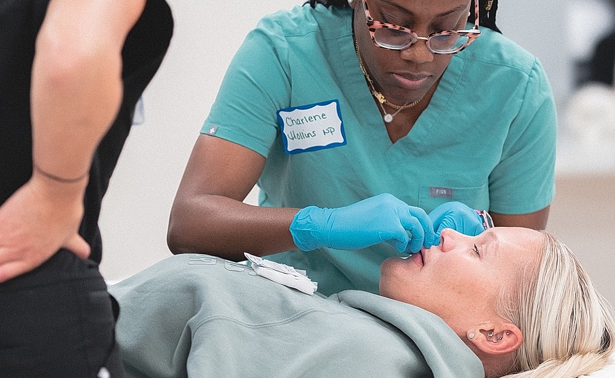 Dental professional assisting patient with oral care.