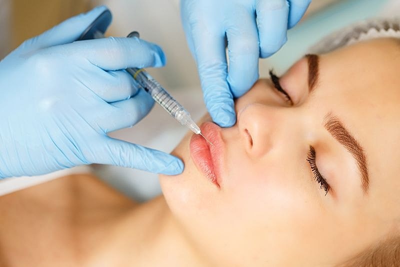 Woman recieving lip filler