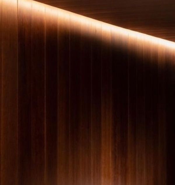 Wooden wall with soft overhead lighting.