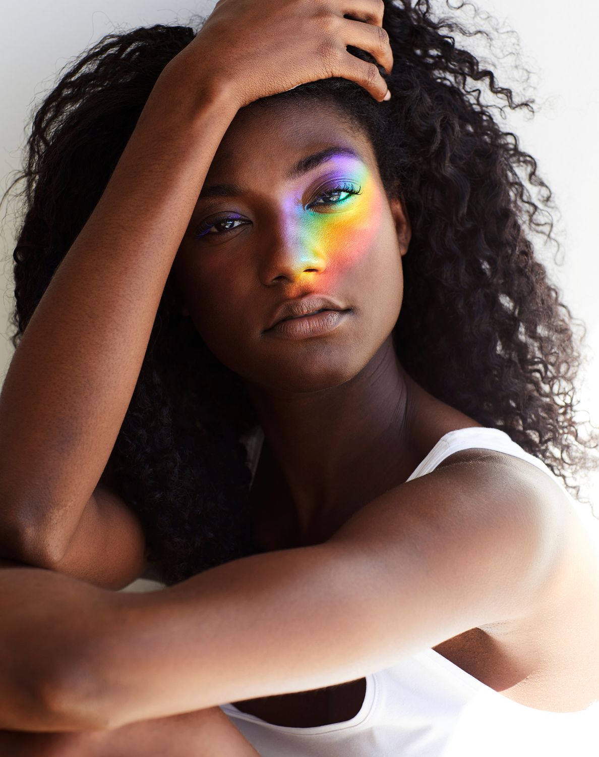 Woman with rainbow light on her face