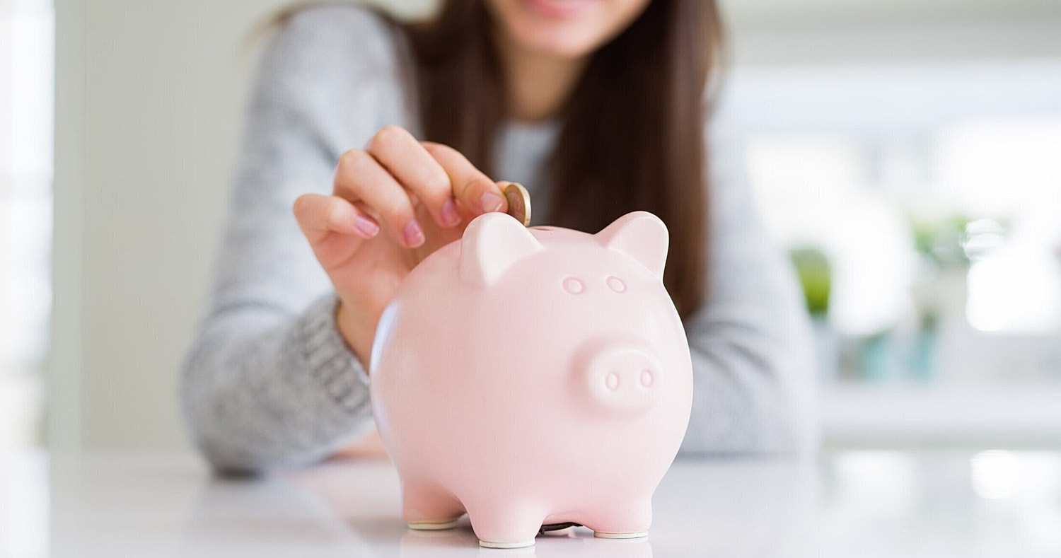 plastic surgery patient model putting a coin in a piggy bank