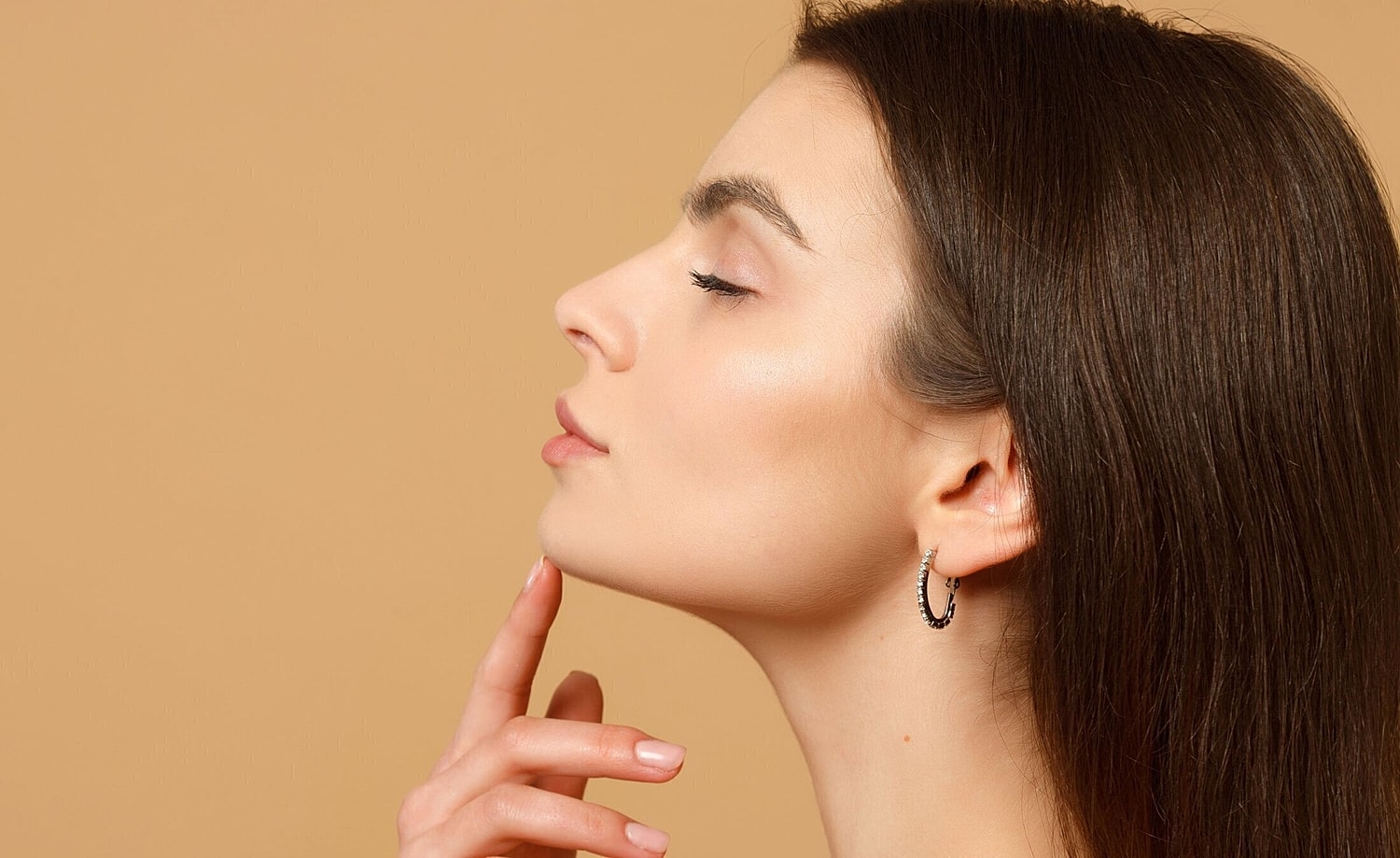 kybella patient model lifting her chin up and touching it with her eyes closed