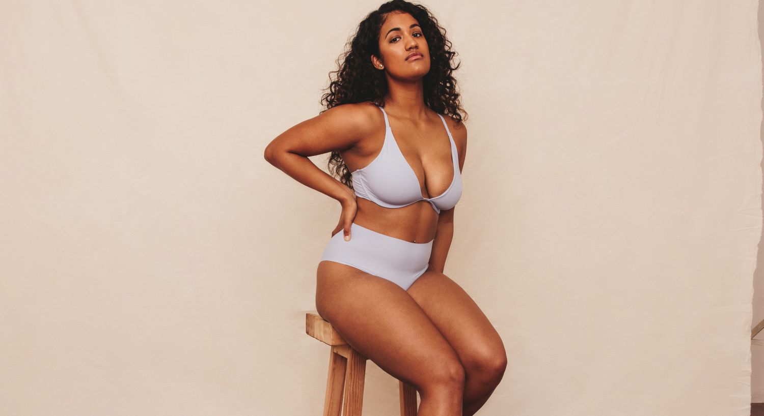 Farmington upper body lift model posing in a light purple bikini.