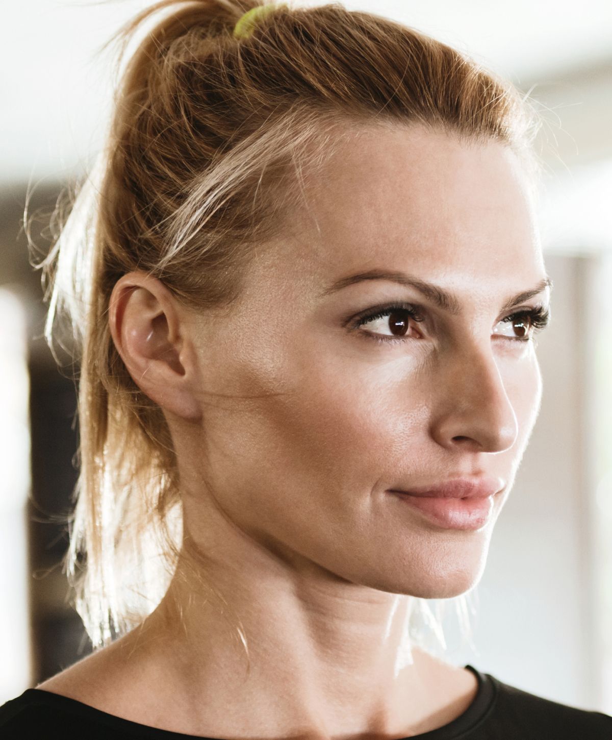 Profile of a Farmington microneedling model with a ponytail.